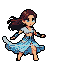 Woman with flowing brown hair in a white crop top and a long, split light blue skirt, dancing barefoot with fluid movements.