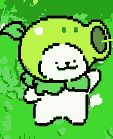 A small, white, anthropomorphic creature with pointed ears and a smiling face, wearing a large, rounded, light green pea shooter-like hat with a darker green rim. Yellow pixels emerge from the hat's opening. The creature has a green collar and stubby limbs, standing with arms slightly raised. The background is an abstract wash of greens.