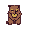 A squat, brown and yellow pixelated creature with a jaguar's body and a human-like face showing narrowed eyes and a grinning mouth.
