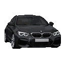 A dark BMW M4 viewed head-on, with glowing white headlights.