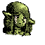 A small, green creature with pointed ears and shaggy hair cries, hunched over with a sorrowful expression.