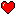 A red heart with a white pixel highlight, on a black background.