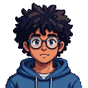 Young person with dark curly afro, blue eyes behind glasses, wearing a blue hoodie and beaded necklace.