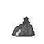 A solitary, pixelated rock formation rises from an infinite black void, its jagged silhouette hinting at hidden depths within a glowing cave entrance. The monochromatic palette amplifies the mysterious and desolate mood of this isolated landscape.