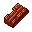 This pixel art shows a reddish-brown plank, a textured resource block reminiscent of crafting or building games. Its angled perspective and coarse pixelation give it a simple, functional feel.