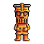 This pixel art features a golden tiki statue with a wide grin and mischievous expression. The cartoonish design and warm color palette give it a playful vibe.