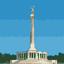 A towering pixel art monument, topped with a classical statue, stands proudly against a clear sky. The intricate stone column and its triumphant figure evoke a sense of history and grandeur. The base has a band of dark green foliage, suggesting an outdoor, possibly park-like, environment.