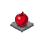 A glossy, stylized red apple, rendered in vibrant pixel art, sits perched on a simple grey platform. The apple's polished appearance and subtle shading give it a three-dimensional, game-item aesthetic.