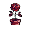 This pixel art presents an abstract, top-down figure in shades of red and pink, its brain-like head and clawed hands creating an eerie, introspective mood. The monochromatic palette and rigid pose evoke a sense of somber mystery.
