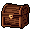 This pixel art image features a closed wooden treasure chest, rendered in isometric perspective with detailed wood grain and a golden-brown latch. Reminiscent of classic RPGs, the chest evokes a sense of hidden loot and nostalgic charm.